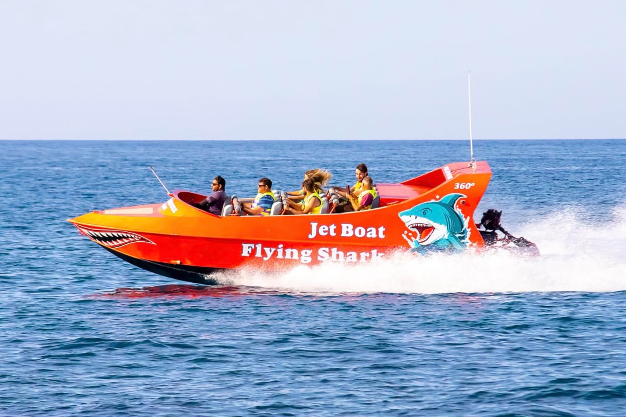 Family fun jet boat experience with scenic coastal backdrop